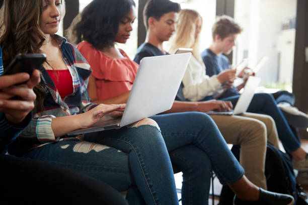 istock Close Up Of A Line Of High School Students Using Digital Devices 999231422