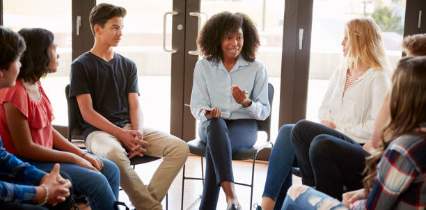 istock Female Tutor Leading Discussion Group Amongst High School Pupils 999231804