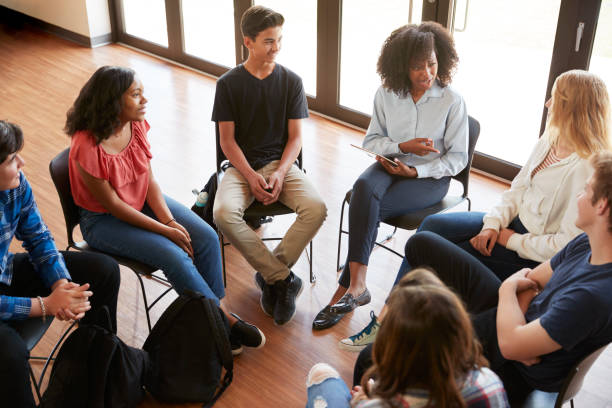 istock Female Tutor Leading Discussion Group Amongst High School Pupils 999231932