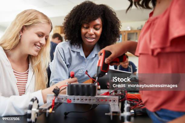 Teacher With Female Pupils Building Robotic Vehicle In Science Lesson Stock Photo - Download Image Now