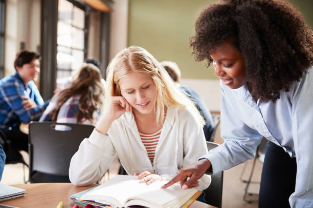istock Female High School Student With Teacher Working At Desk 999246274