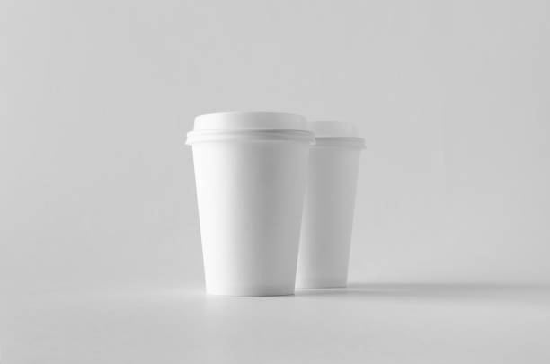 istock 12 oz. white coffee paper cup mock-up with lid. 999254184