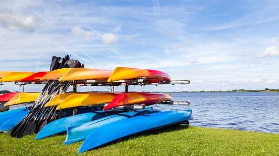 Water landscape with colorful rental canoes in the harbor of  a lake called Leekstermeer in Drenthe in the Netherlands