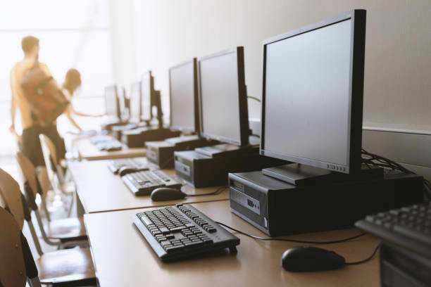 Row of desktop computers in classroom Row of desktop computers in classroom setting. computer store stock pictures, royalty-free photos & images