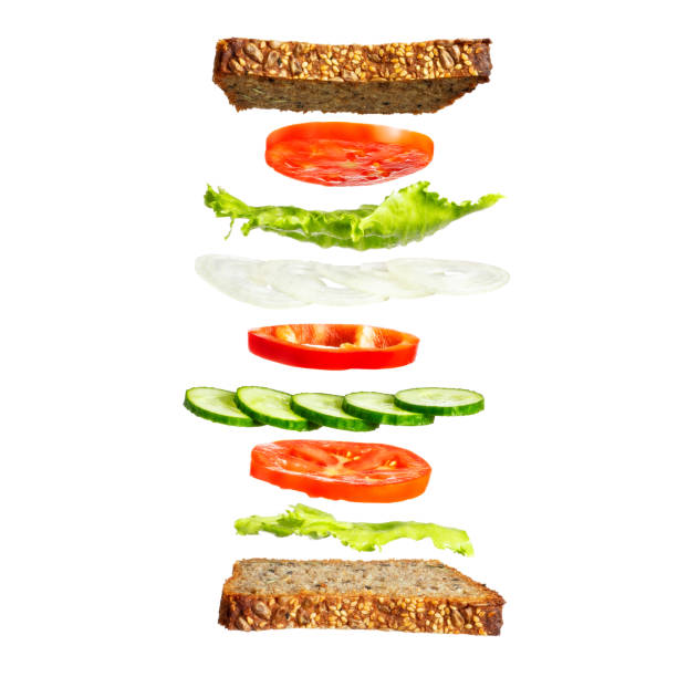 istock Sandwich with vegetables. Vegetarian sandwich with rye bread, lettuce, tomatoes and cucumbers. Vegetable ingredients, floating in the air. 999257804