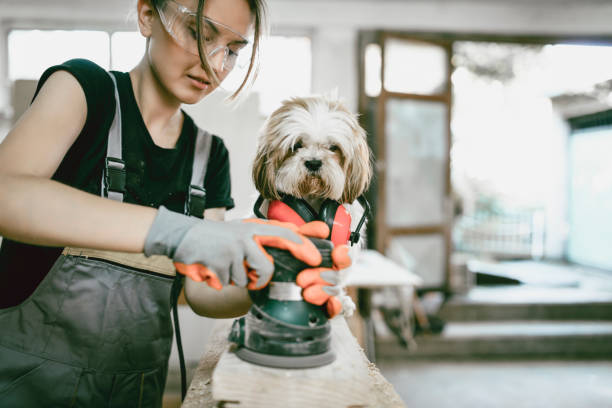 istock Female Sewing Plank While Cute Puppy Assists 999274948