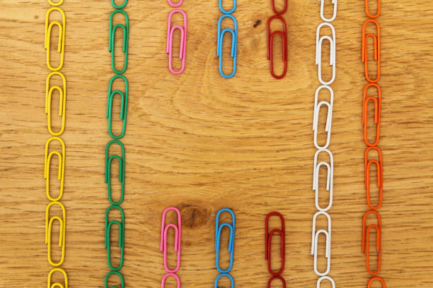 istock Colourful Paperclips Flat Lay on Wood Background Straight Lines Text Space 999304944