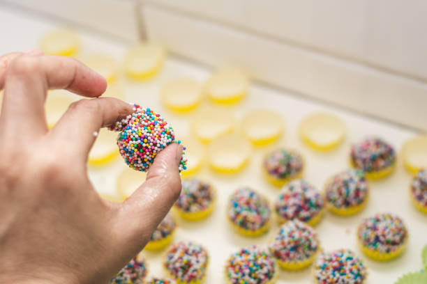 Woman hands preparing brigadeiro. Handmade brazilian chocolate candy. Top view. Selective focus