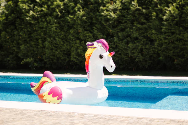istock Inflatable pool toy - giant rideable unicorn. 999309184