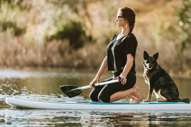 istock Woman On Paddleboard With Pet Dog 999311834