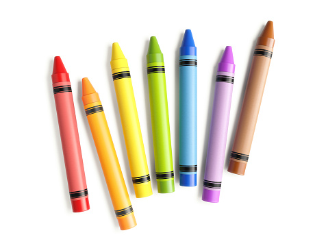 Colorful crayons scattered on white background. Horizontal composition with copy space.