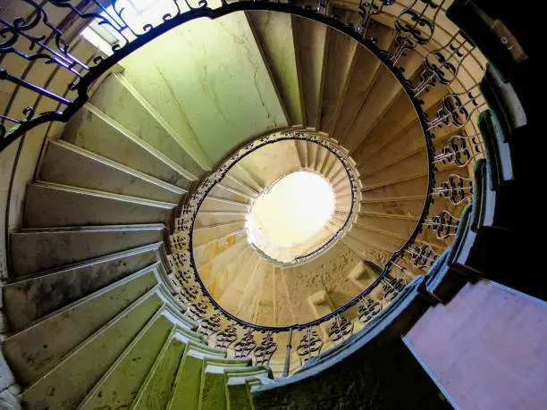 A spiral staircase viewed from below