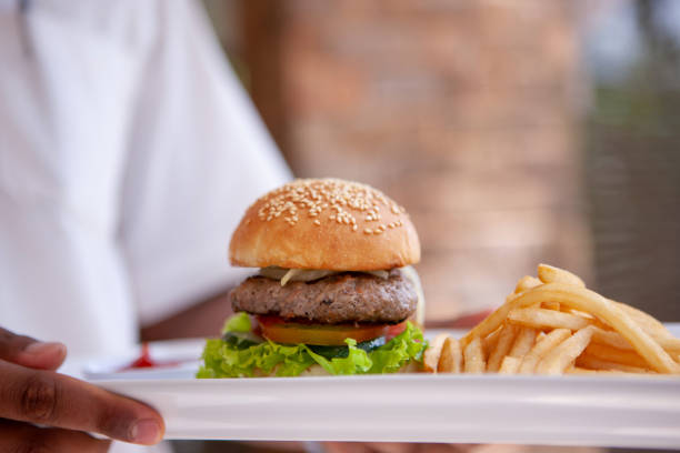 istock Serving burger with french fries 999349038