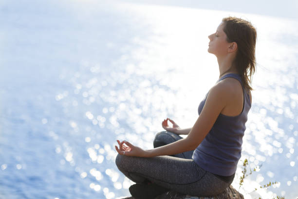 istock Young woman meditating 999388110