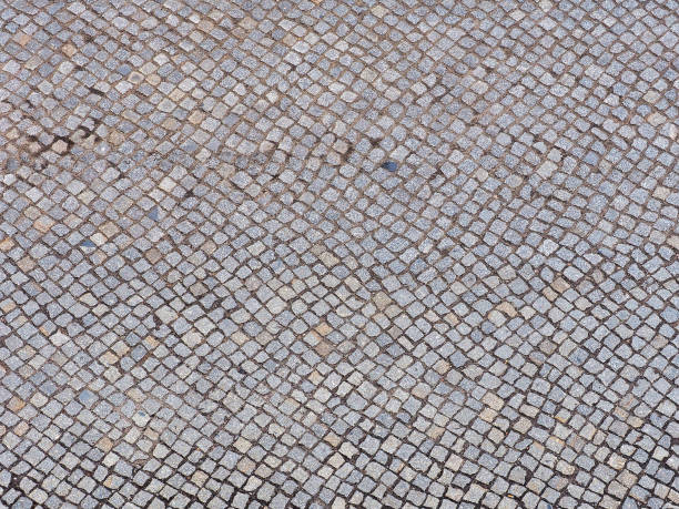 istock Ancient paving stone background, top view, close-up. Old stone pavement 999390246