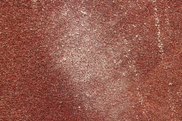 istock Red Sandpaper Texture. Rough Grit Abrasive Background. Used Grain Emery Backdrop. 999405118