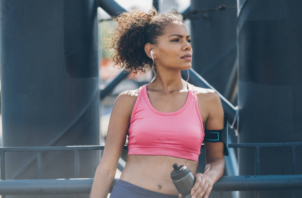 istock Sports woman drinking water 999410710
