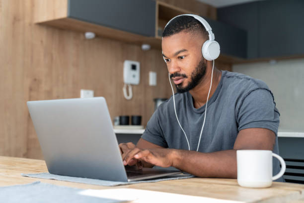 istock African American man at home working online on a laptop computer 999411238