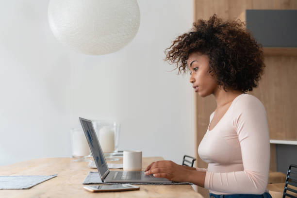 istock Woman at home working online on a laptop computer 999411250