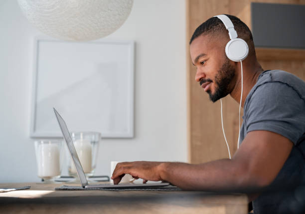 istock Man at home working online on a laptop computer 999411454