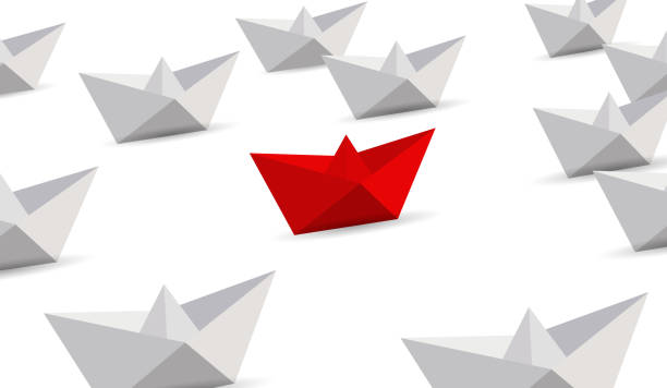 istock Leadership concept. Red and white paper boats. 999437248
