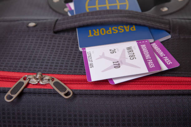 istock Black Suitcase and two tickets for airplane with passports 999445534