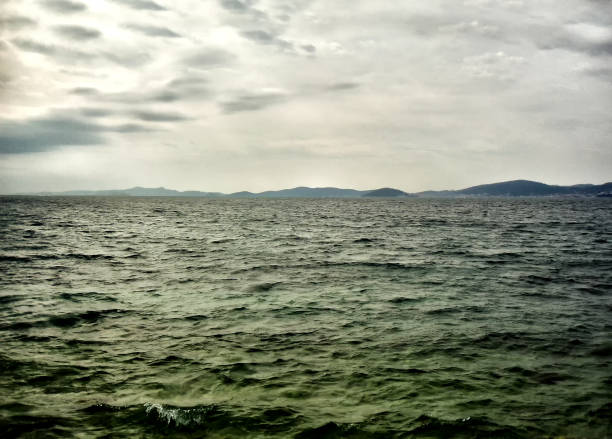 istock Cloudy day on the wavy sea 999473432