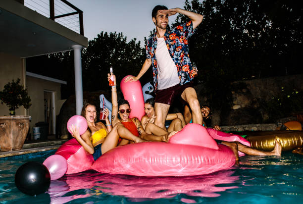 istock Friends partying in a pool in evening 999480888