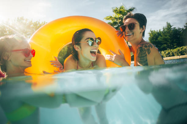 istock Women friends having fun together in pool 999482148