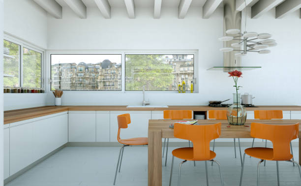 istock White modern kitchen in a house with orange chairs and wooden table 999490558