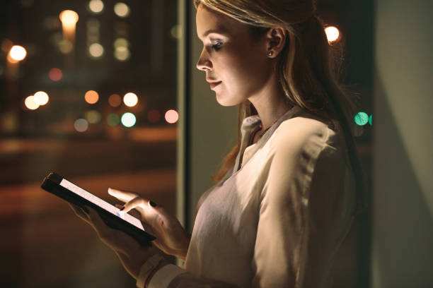 istock Beautiful female working late night in office 999493840