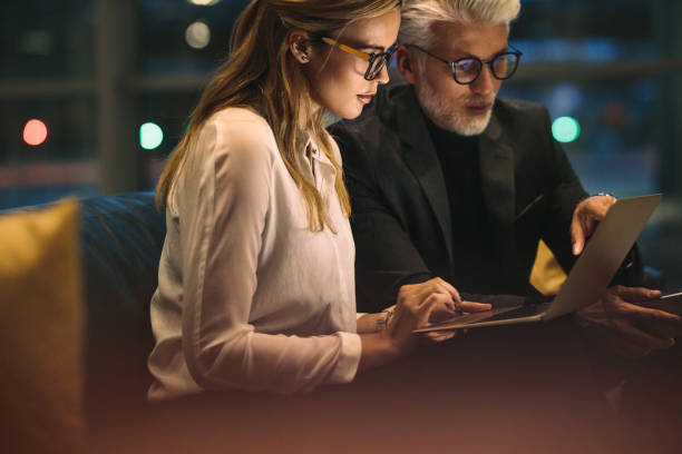 istock Business professionals working late in office 999494174