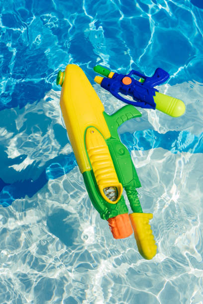 istock plastic colorful water guns floating in swimming pool 999494602