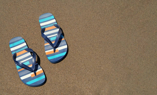 istock blue slippers on the beach  on the sand 999504174