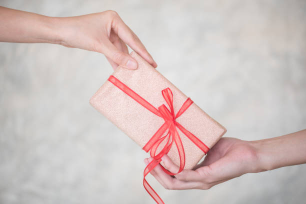 istock Close-Up Of Hands Holding Gift Box 999548266