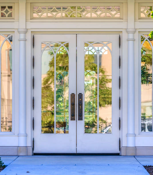 istock Reflective glass windows on outside wooden door 999597094