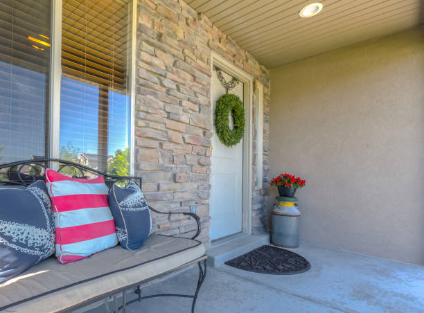 istock Stone wall entry with bench near front door 999597204