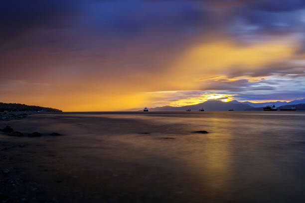 istock sea inlet raining while sun setting down, Vancouver, British Columbia 999608744