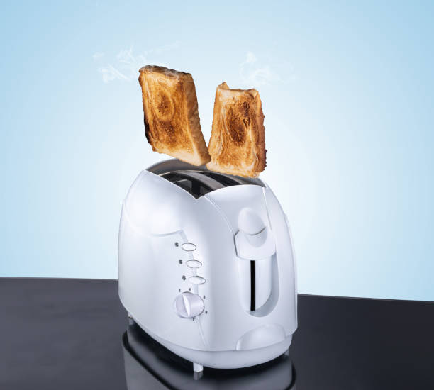 istock Toaster composite image and bread, flying and jumping bread cooked from an eletric toaster, blue background and reflective surface 999619274