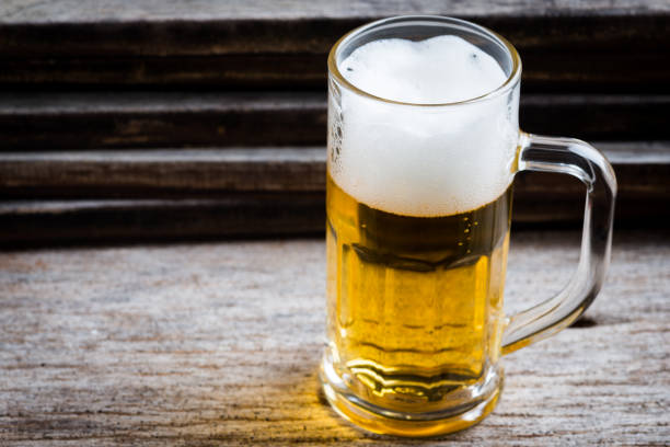 istock mug of beer on wood background 999635640