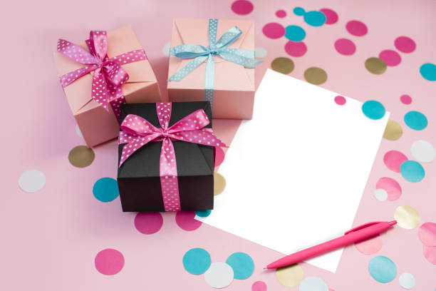 istock Decorated boxes, confetti and blank white sheet of paper 999645364