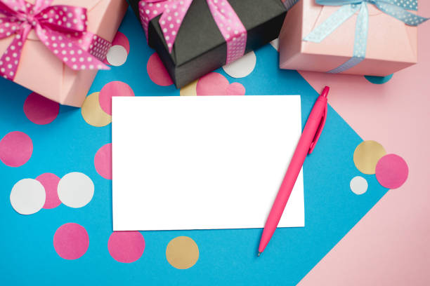 istock Decorated boxes, confetti and blank white sheet of paper 999645456