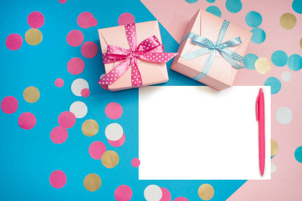 istock Decorated boxes, confetti and blank white sheet of paper 999647534