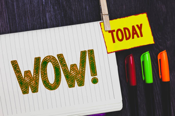istock Handwriting text writing Wow Motivational Call. Concept meaning Expression of somebody speechless amazed overjoyed Papers marker pens nice art daily creative work wood colour black shadow. 999648238
