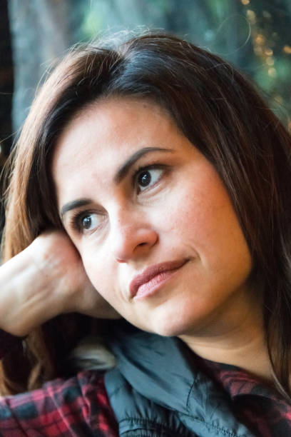 istock Sad mature woman looking through a window 999649766