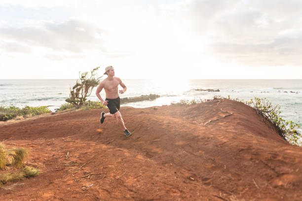 istock Solo shirtless jogger on Hawaii coastline 999669944