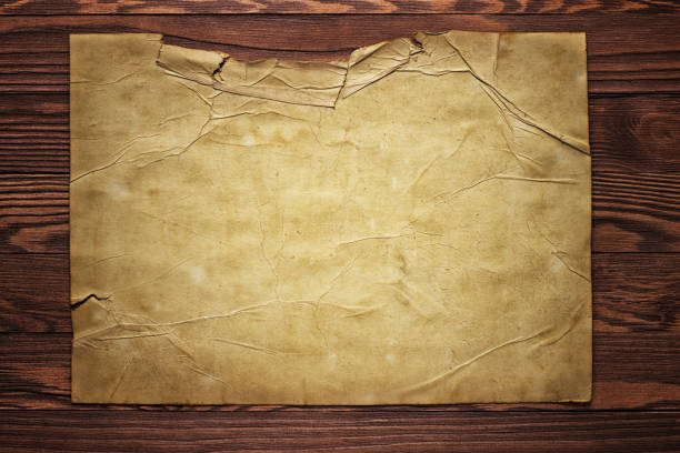 istock Piece of old paper on wood texture background 999670654