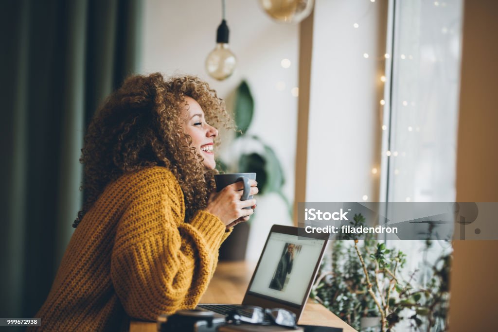 Enjoying of work and coffee Young woman Enjoying of work and coffee Women Stock Photo