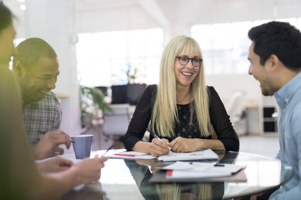 istock Middle-aged female leading a business strategy meeting 999675946