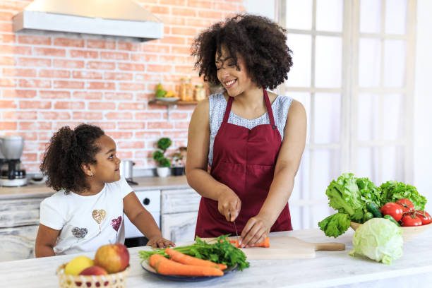 istock Mother and child preparing healty meal 999676362